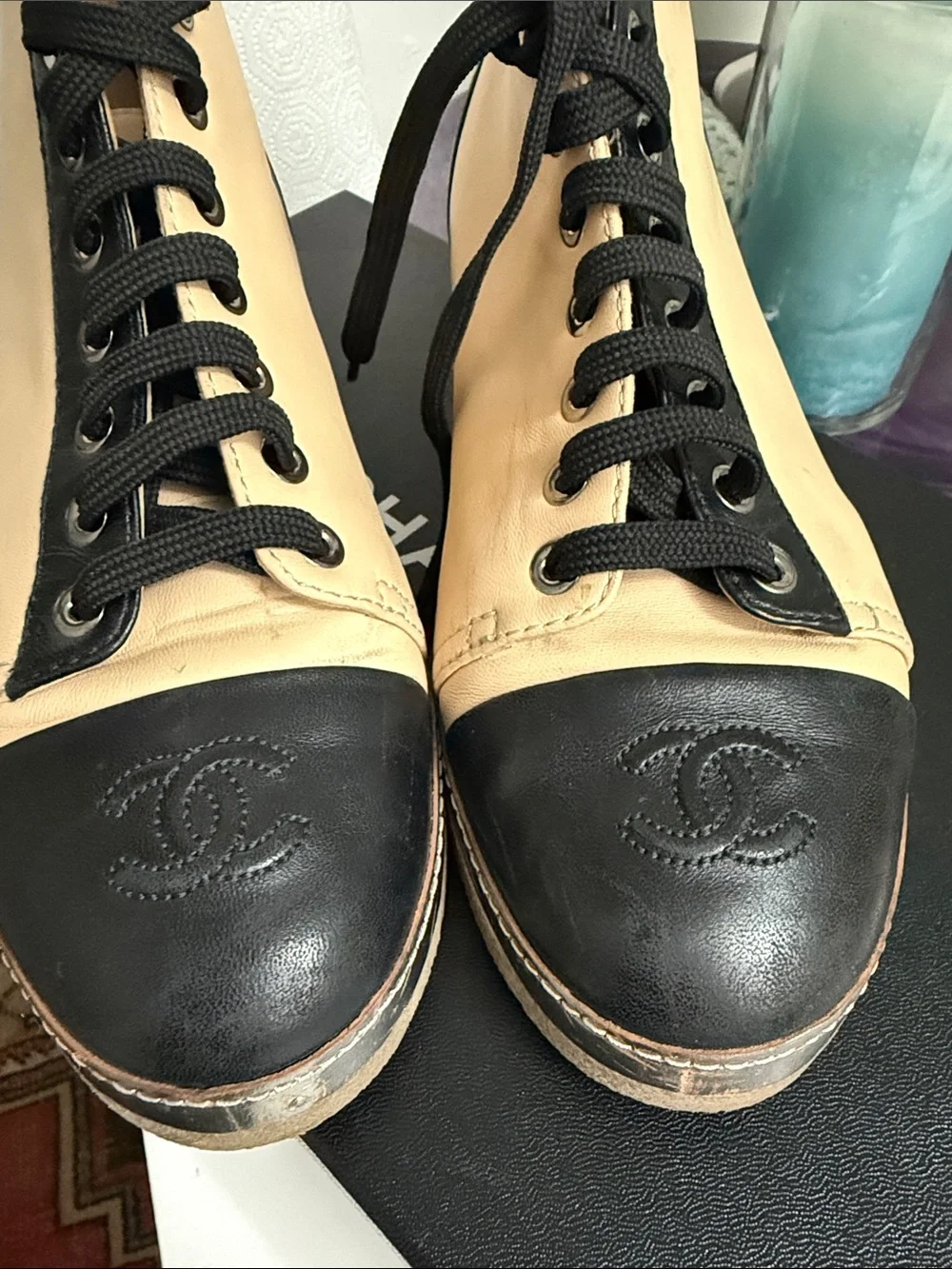 CHANEL Two-Tone Leather High-Top Sneakers in Beige & Black